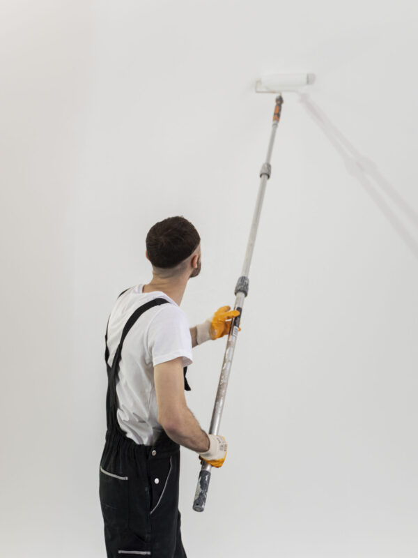 medium-shot-young-man-painting-wall